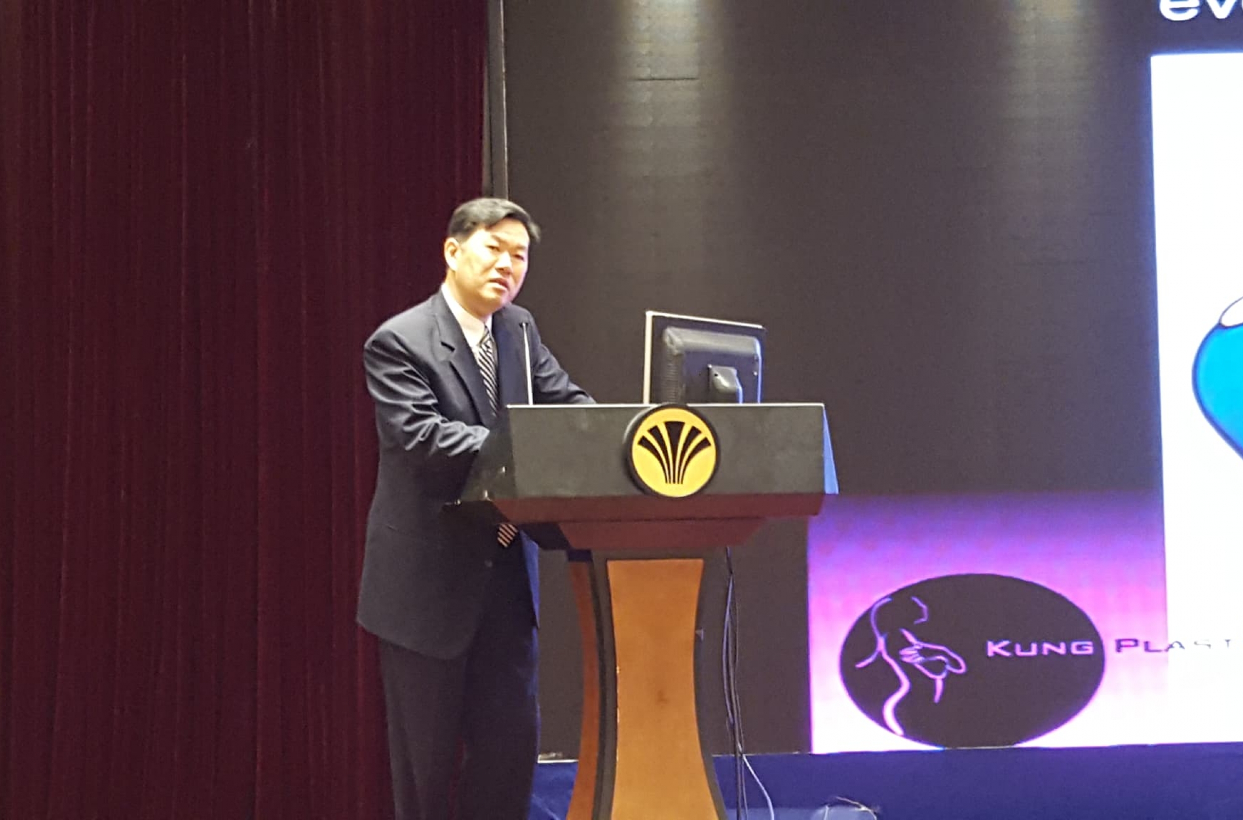 Dr Kung speaking at a podium