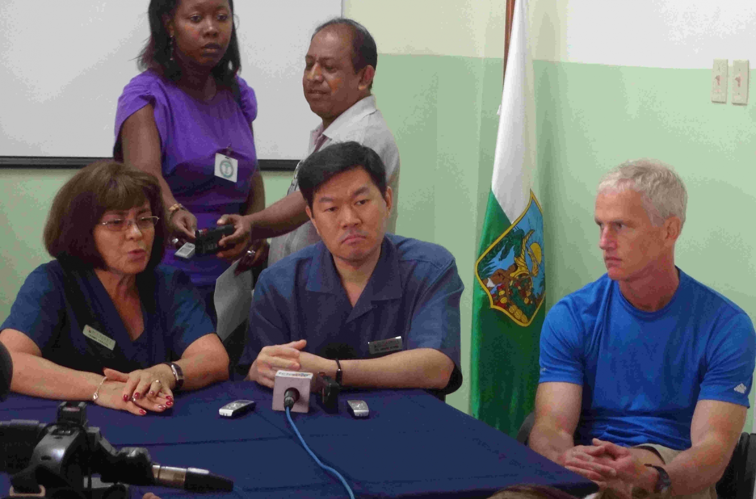 Dr. Kung sitting with the press